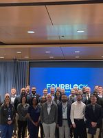 Four Block Partnership Members posing in an auditorium
