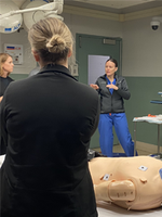 Navy Medical staff standing in hospital teaching setting