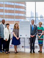 Penn Medicine and VA representatives posing together around a sign