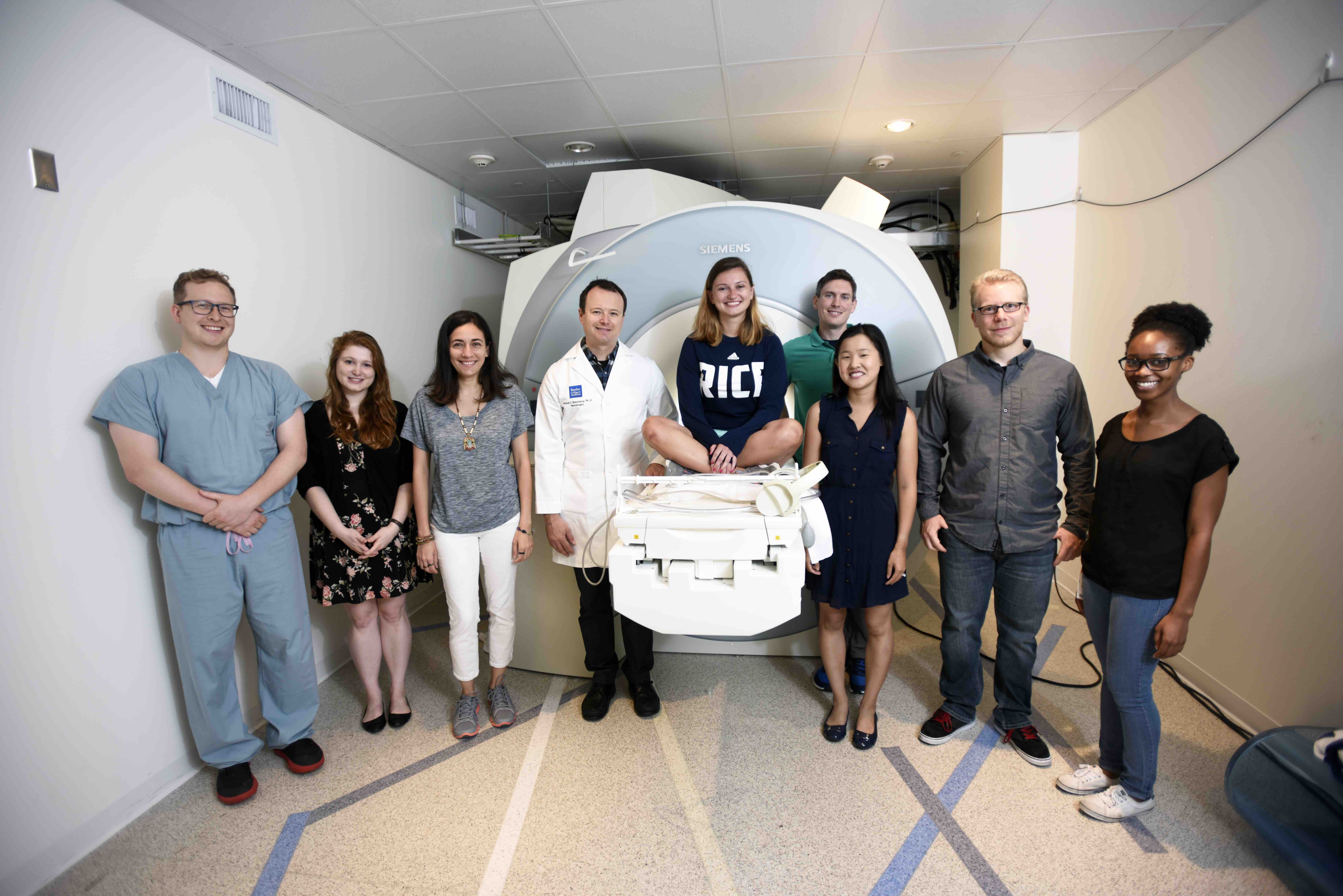 Photo of lab members with MRI scanner.