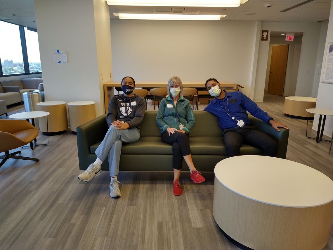 3 members of the CCRU team masked, seated on a couch in the Pavilion.