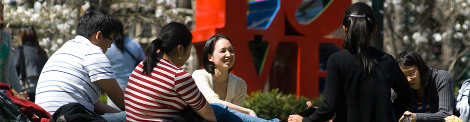 Students sitting in front of the LOVE sign