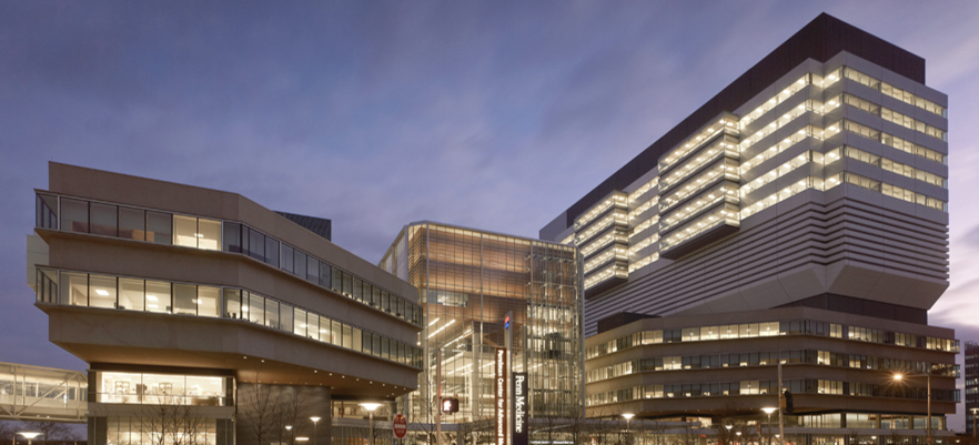 evening image of two large connected buildings