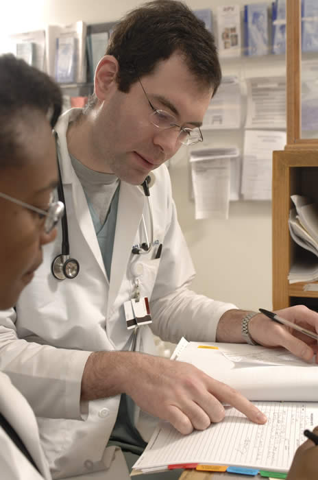 Two researchers reviewing a file