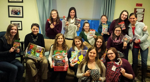 Students with gifts for the Adopt a Family program
