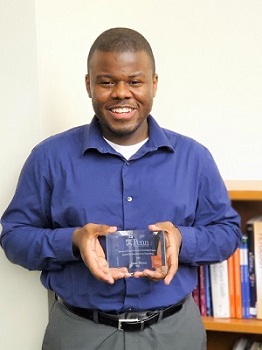 Isaac Elysee with his Excellence in Counseling Award
