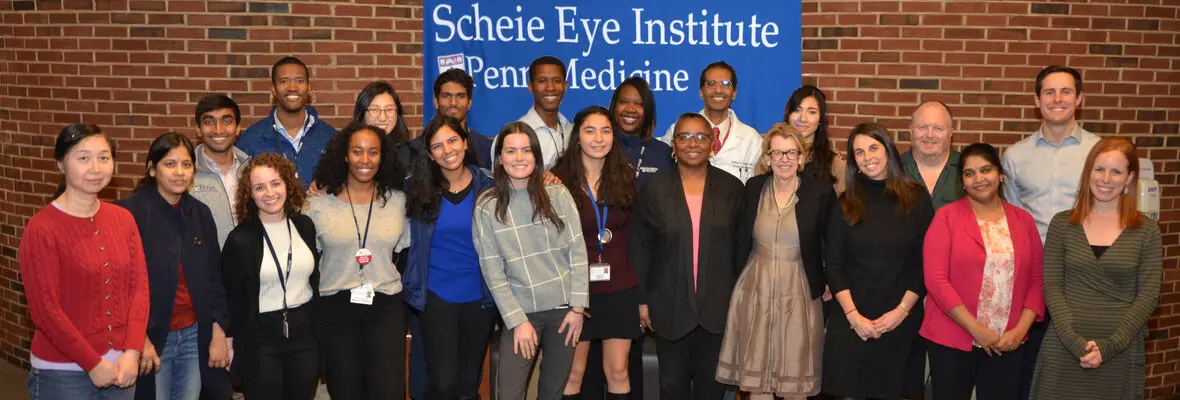 Group of lab members in front of Scheie Eye Institute