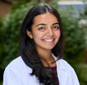 Tanvi Joshi in a whitecoat with greenery in background