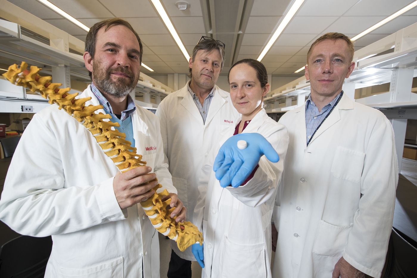 Dr. Sarah Gullbrand, Dr. Robert Mauck, Dr. Harvey Smith, and Dr. Thomas Schaer showcasing their tissue engineered intervertebral disc constructs alongside model of a human spine. 