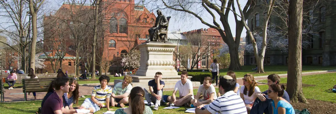 students sitting on lawn for outdoors class