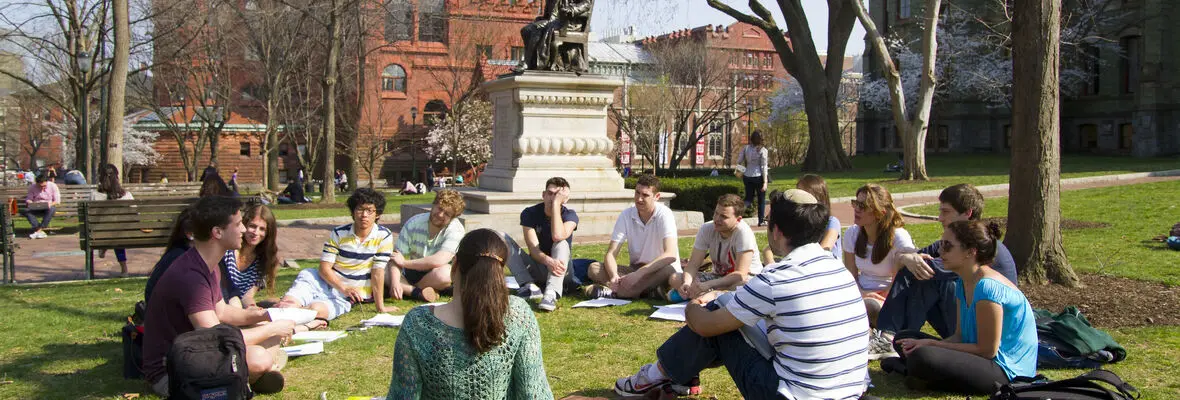 students sitting on lawn for outdoors class