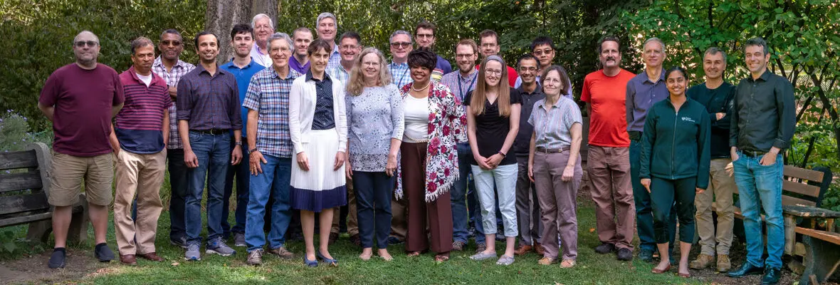 A group of people standing and smiling at the camera