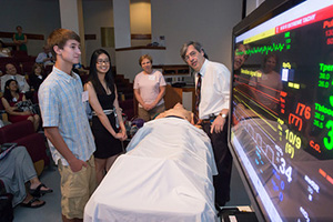 Gregg Lipschik, M.D., demonstrating a simulated clinical experience on the Sim Man mannequin.