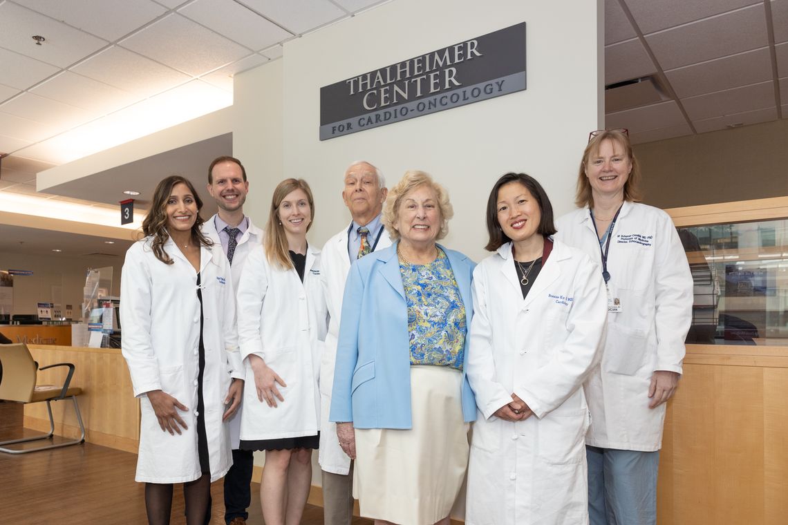 Joan Thalheimer with Cardio-Oncology Providers under the Thalheimer Center for Cardio-Oncology sign