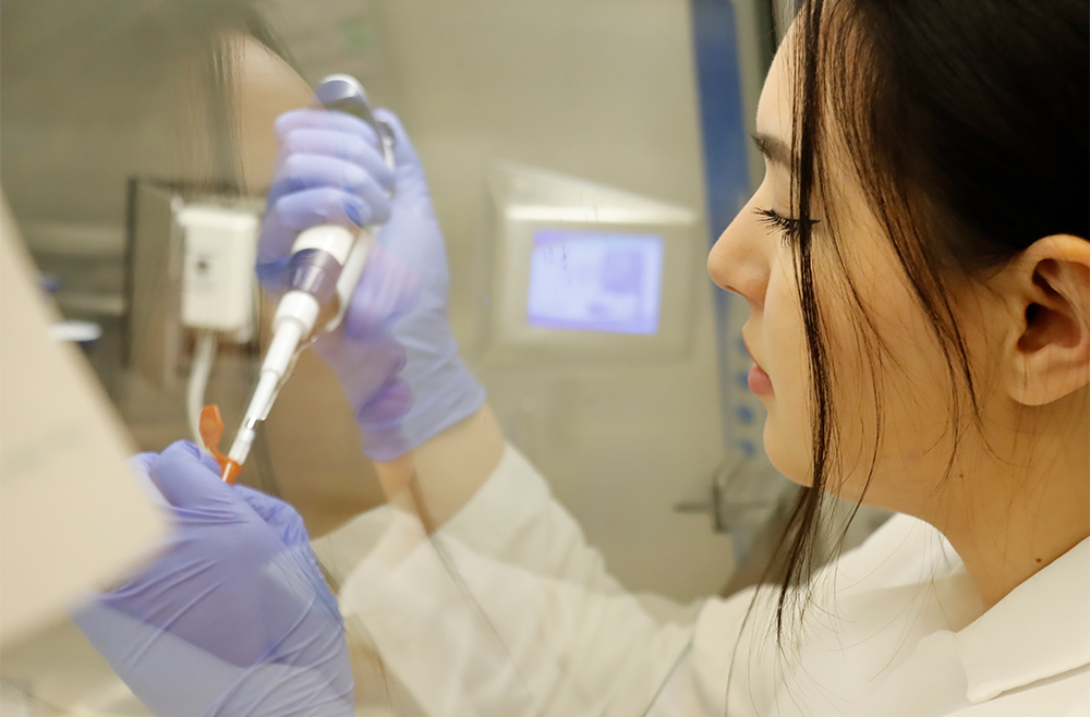 A close-up shot of Robin Wilder, lab personnel at Uyhazi Lab, using laboratory equipment.