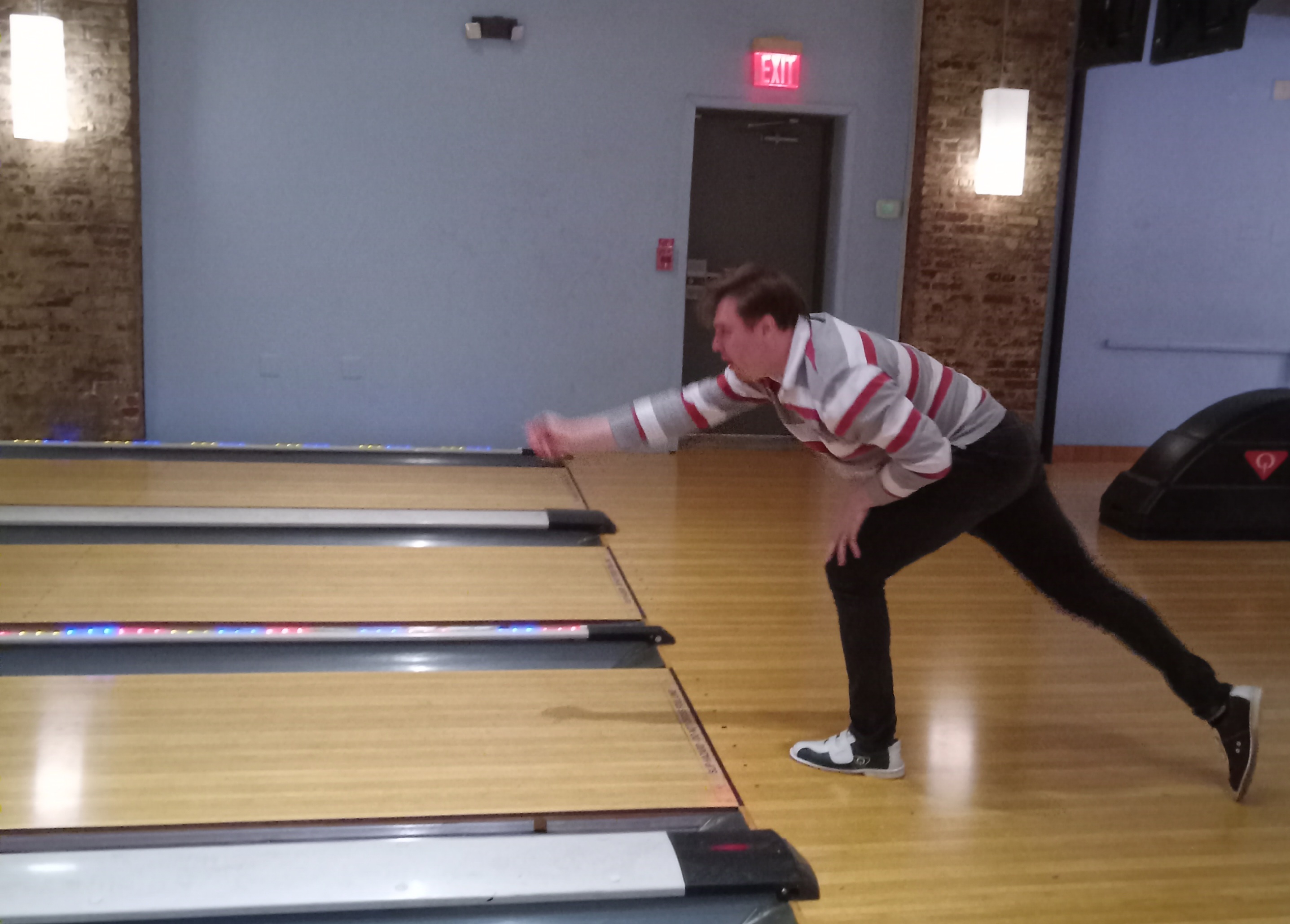 Lab member pictured just as he rolls his ball down lane