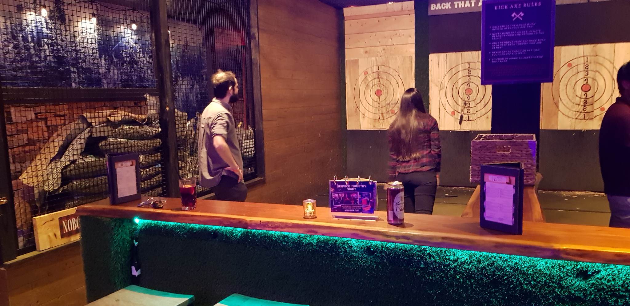 Lab members throw axes at targets