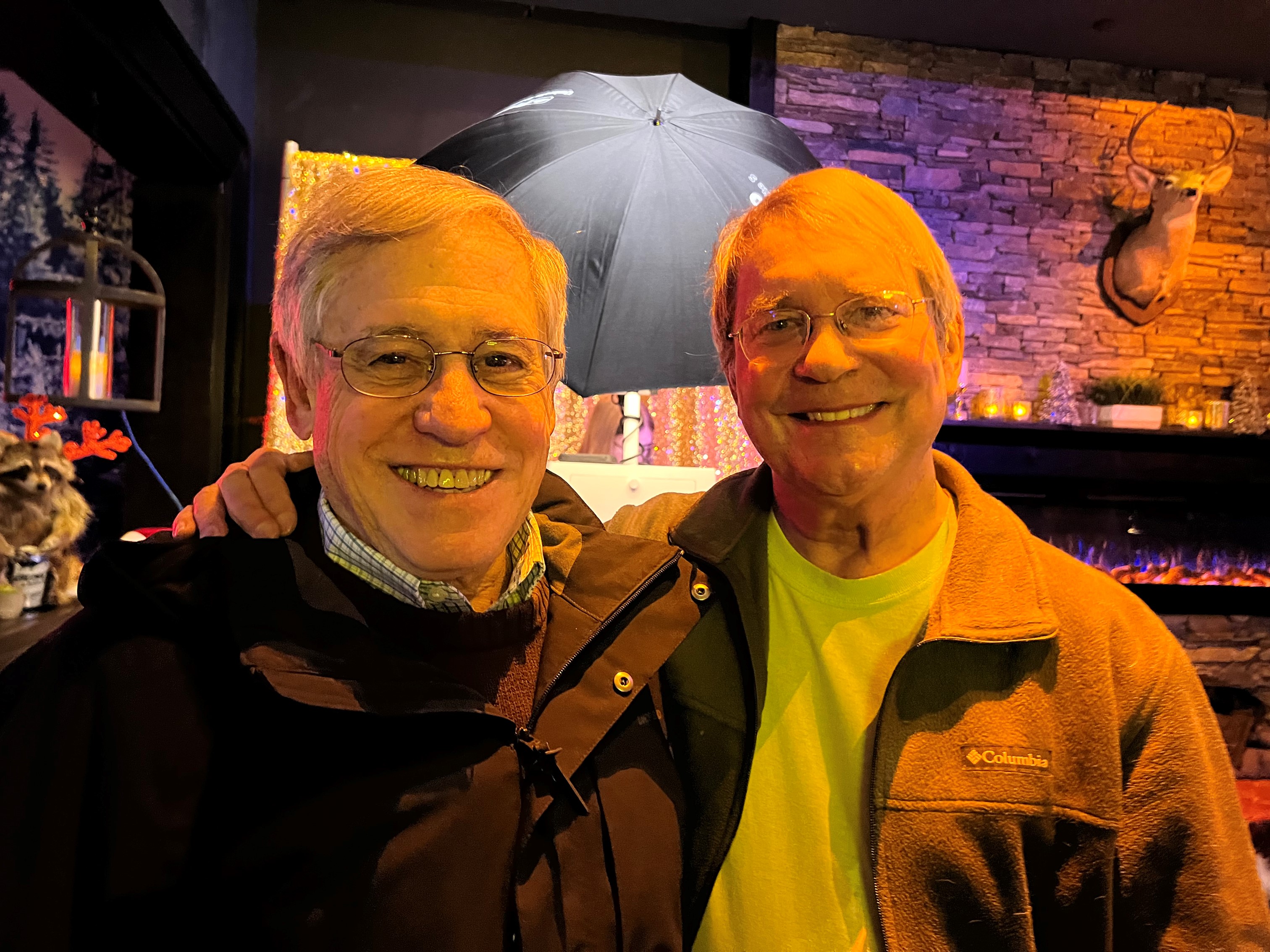 Two guests smile for the camera in the lounge area