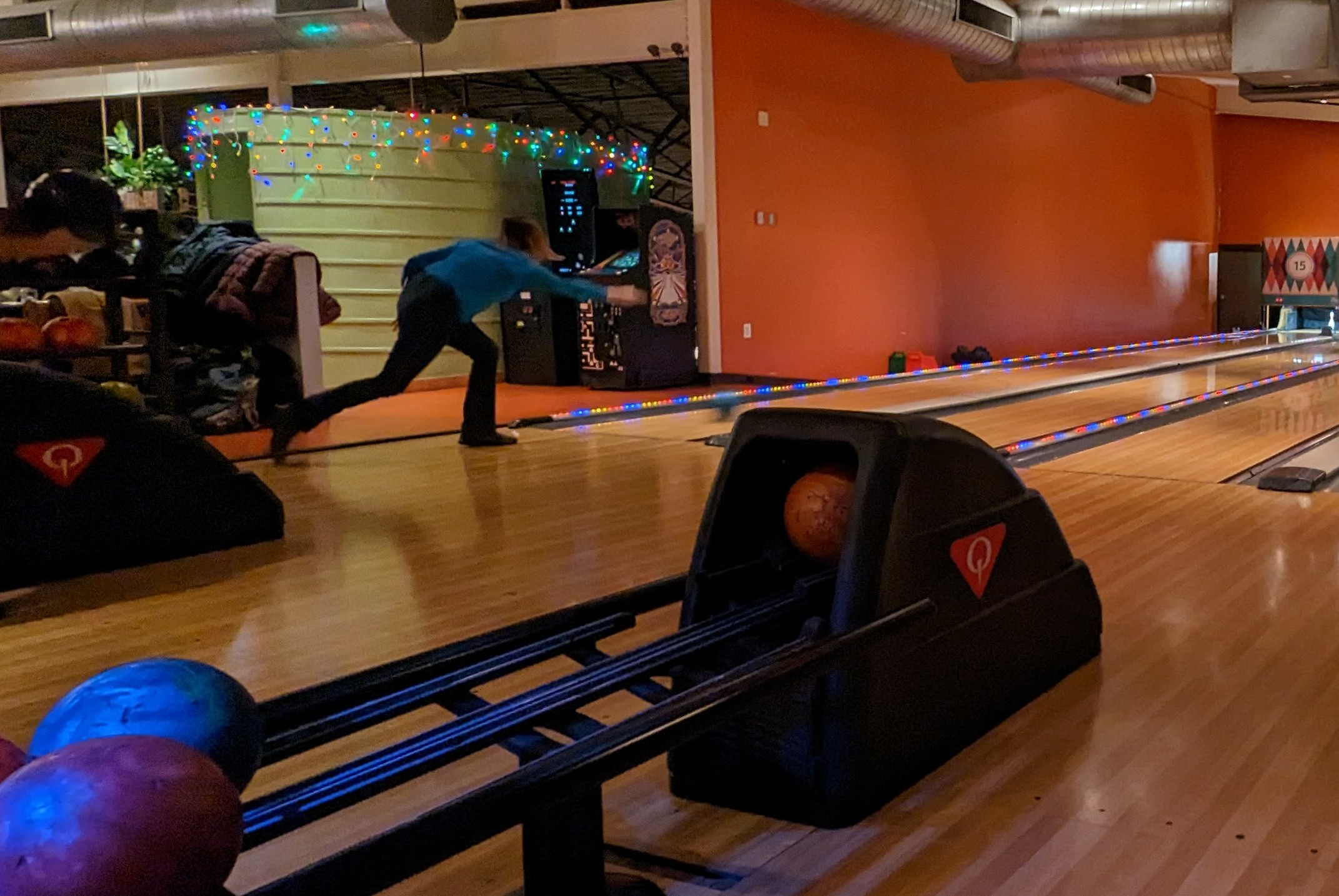 Picture of lab member just as they roll bowling ball down the lane