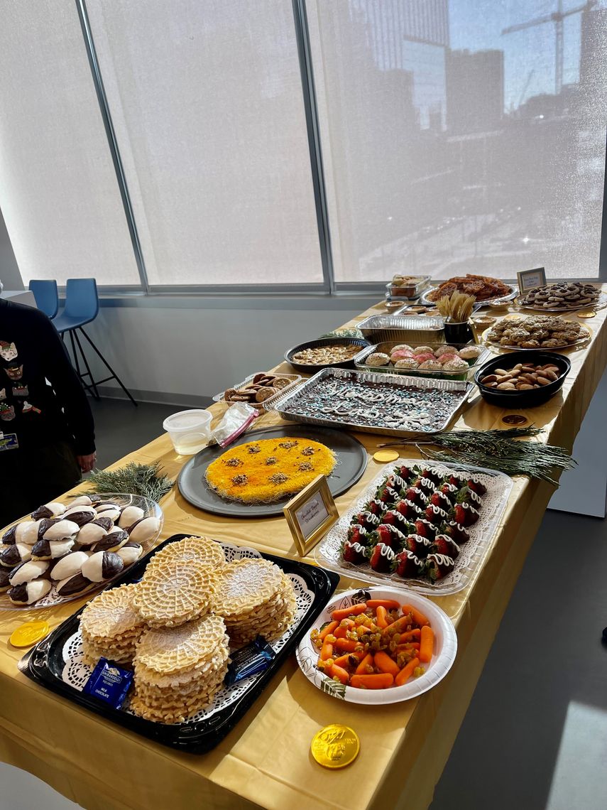 Table with catered food and pot-luck food from lab members