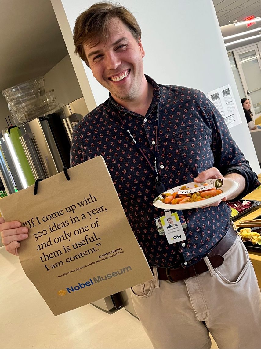 Ted Kreider holds plate of food and smiles