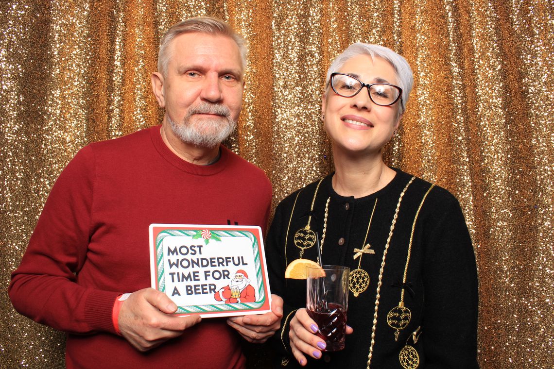 Two people smile and pose in photo booth