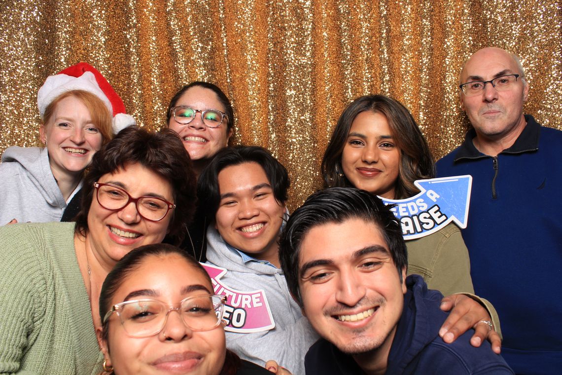 Lab members smile while posing in photo booth