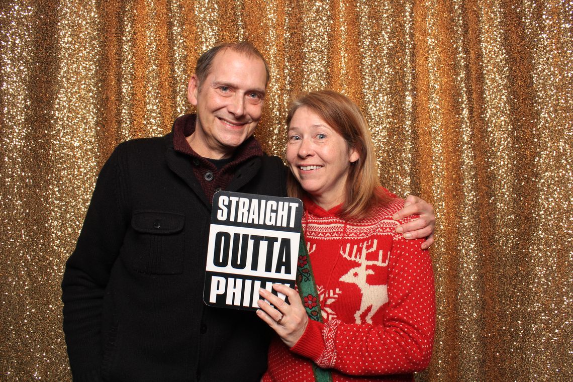 Two people smile and pose in photo booth