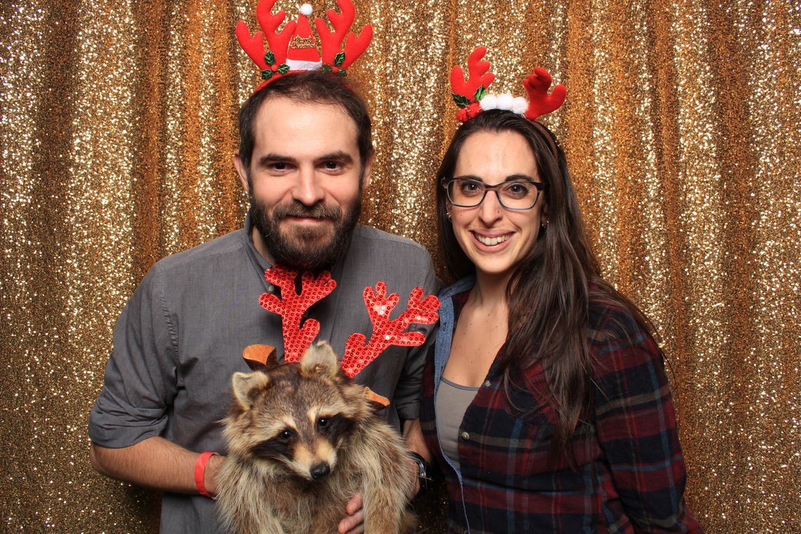 Two people smile and pose in photo booth