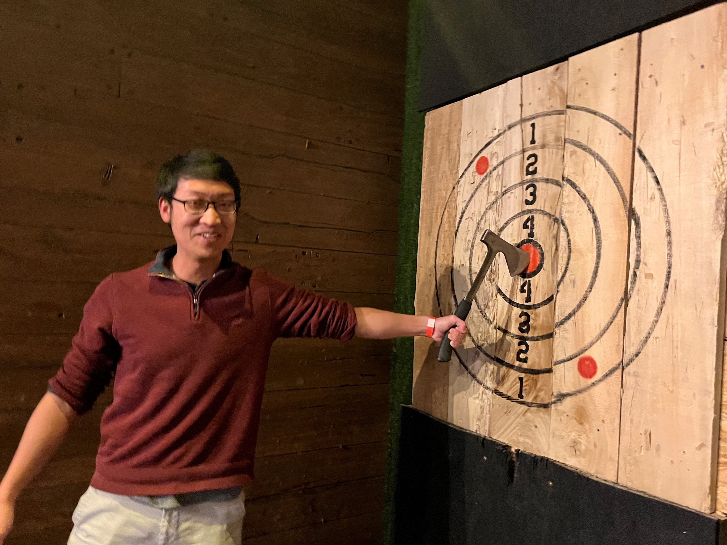 Lab member shows his axe in the bullseye of target