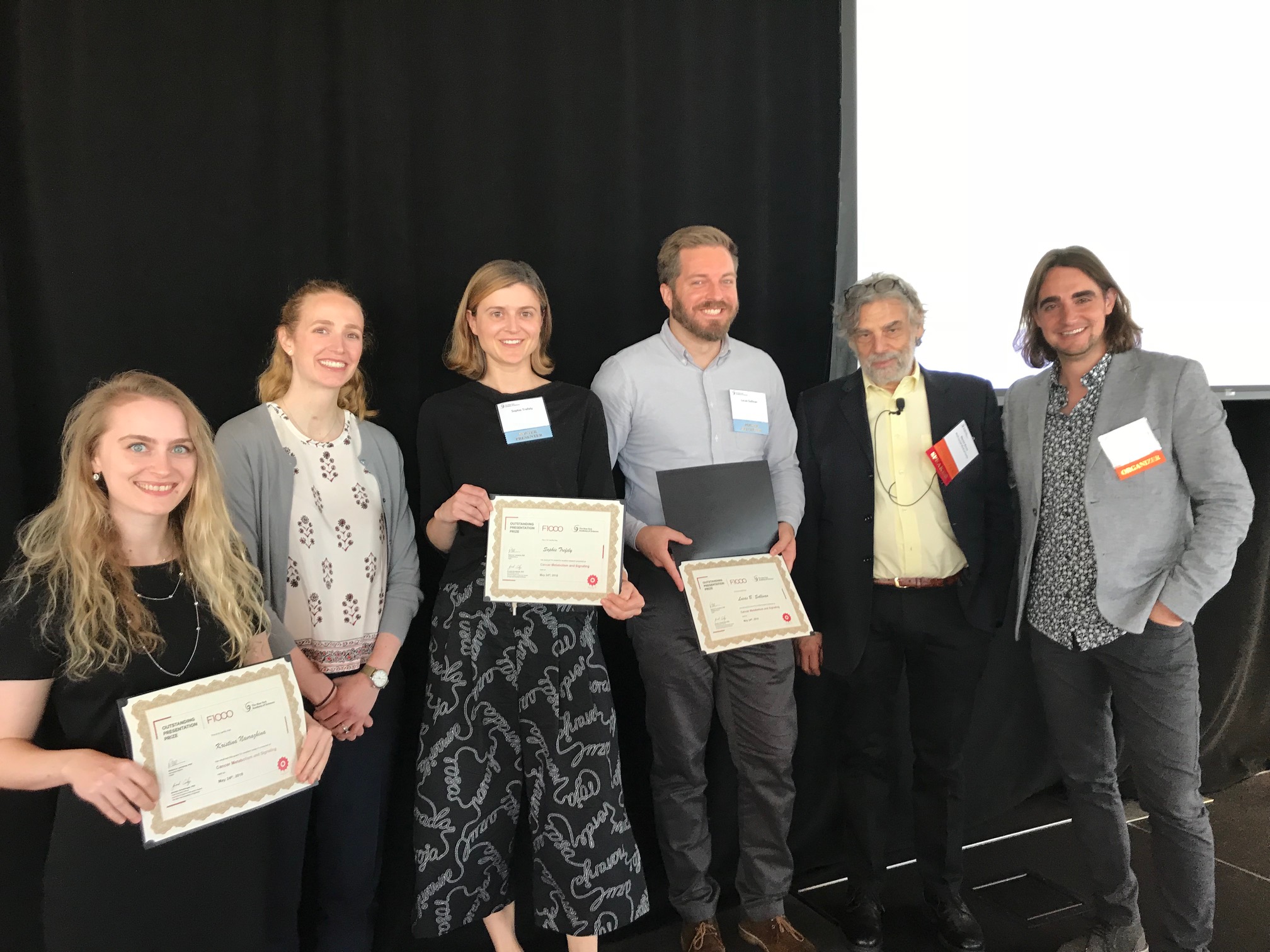 Sophie winning a poster award at the NYAS Cancer Metabolism and Signaling Symposium